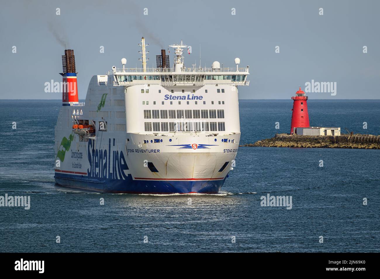 The ferry Stena. Adventurer passing the Poolbeg Lighthouse which stands at the end of the South Wall at the entrance to the port of Dublin - May 2022. Stock Photo