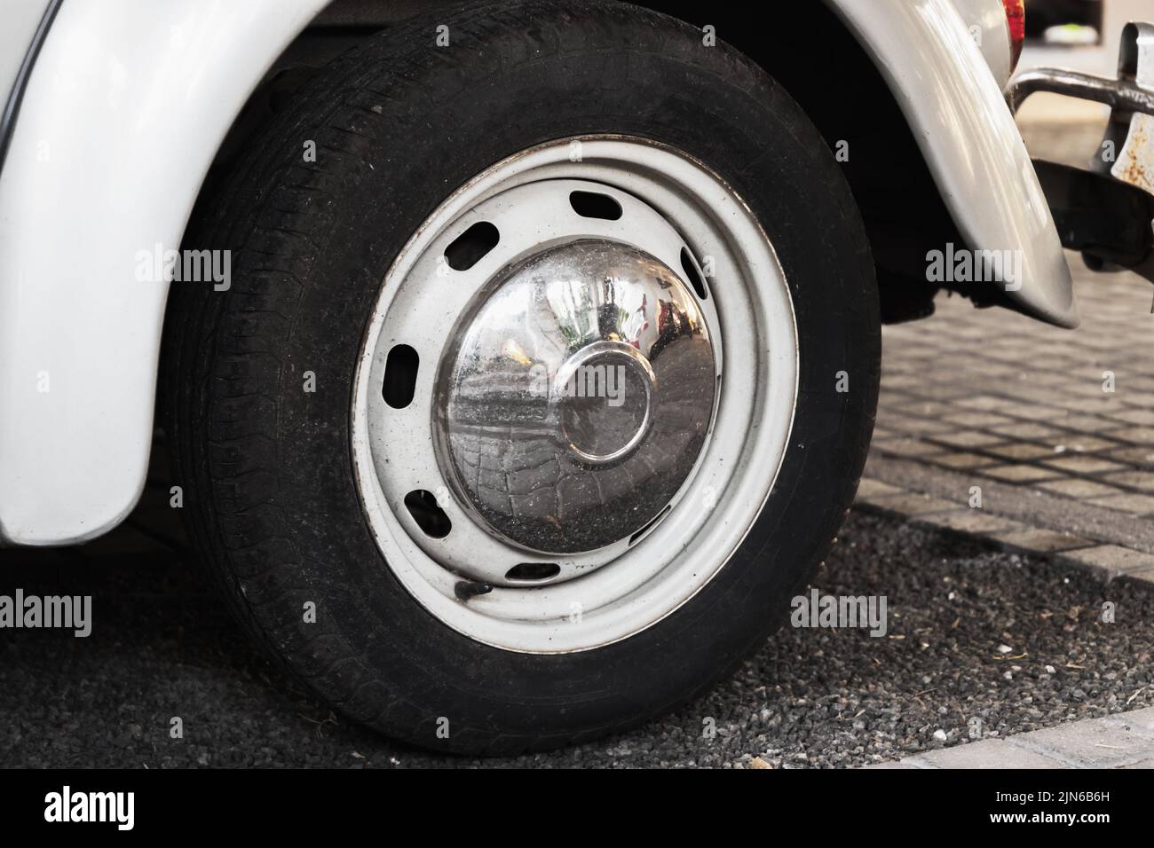 Vintage front car wheel with chromed cap, close up photo Stock Photo
