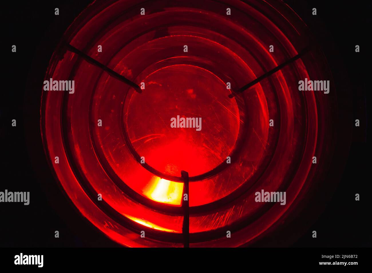Red leading light is behind a Fresnel lens. It is a type of composite compact lens developed by the French physicist Augustin-Jean Fresnel for use in Stock Photo