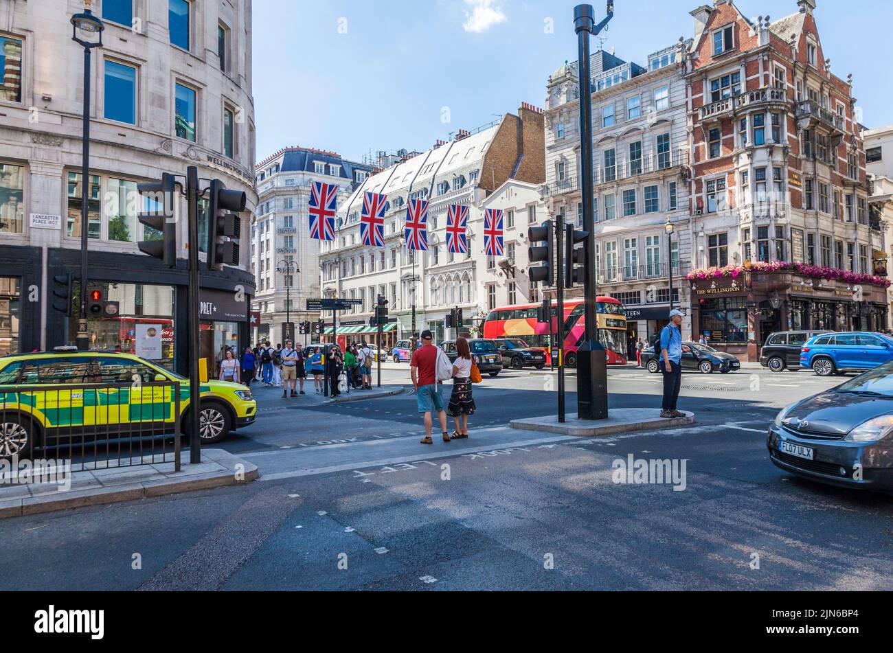 A street scene in the West End of London,England,UK with Union Jack flags draped across the street Stock Photo