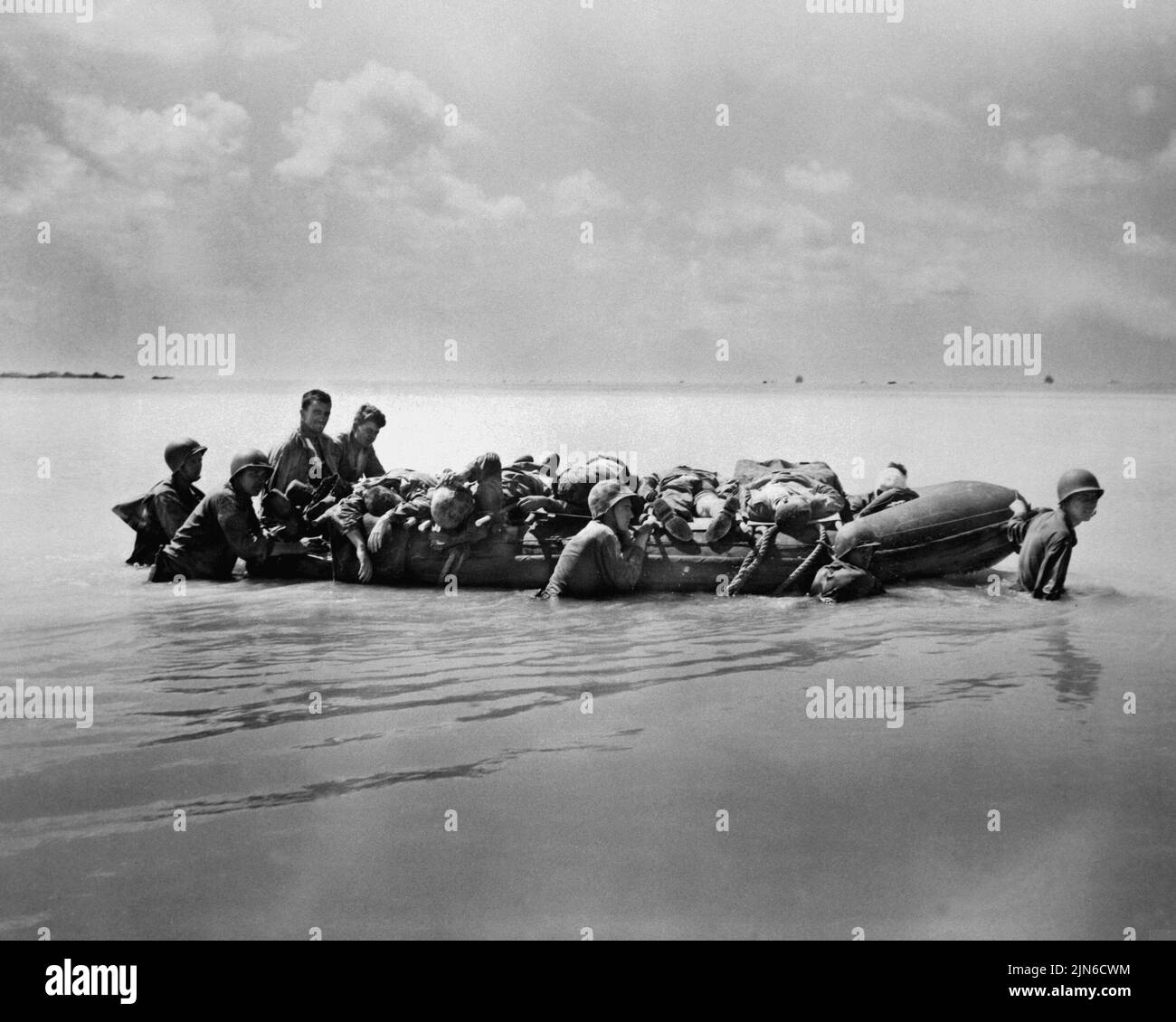 TARAWA, PACIFIC OCEAN - November 1943 - US Marines wounded during the landing on Tarawa are towed out on rubber boats by their buddies to larger vesse Stock Photo
