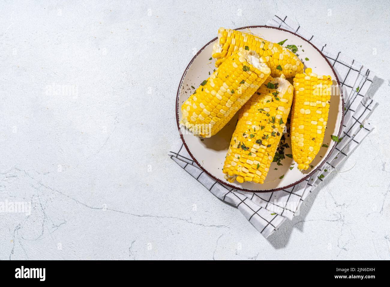 Boiled corn with butter and herbs. Ripe yellow organic cooked corn cobs ...