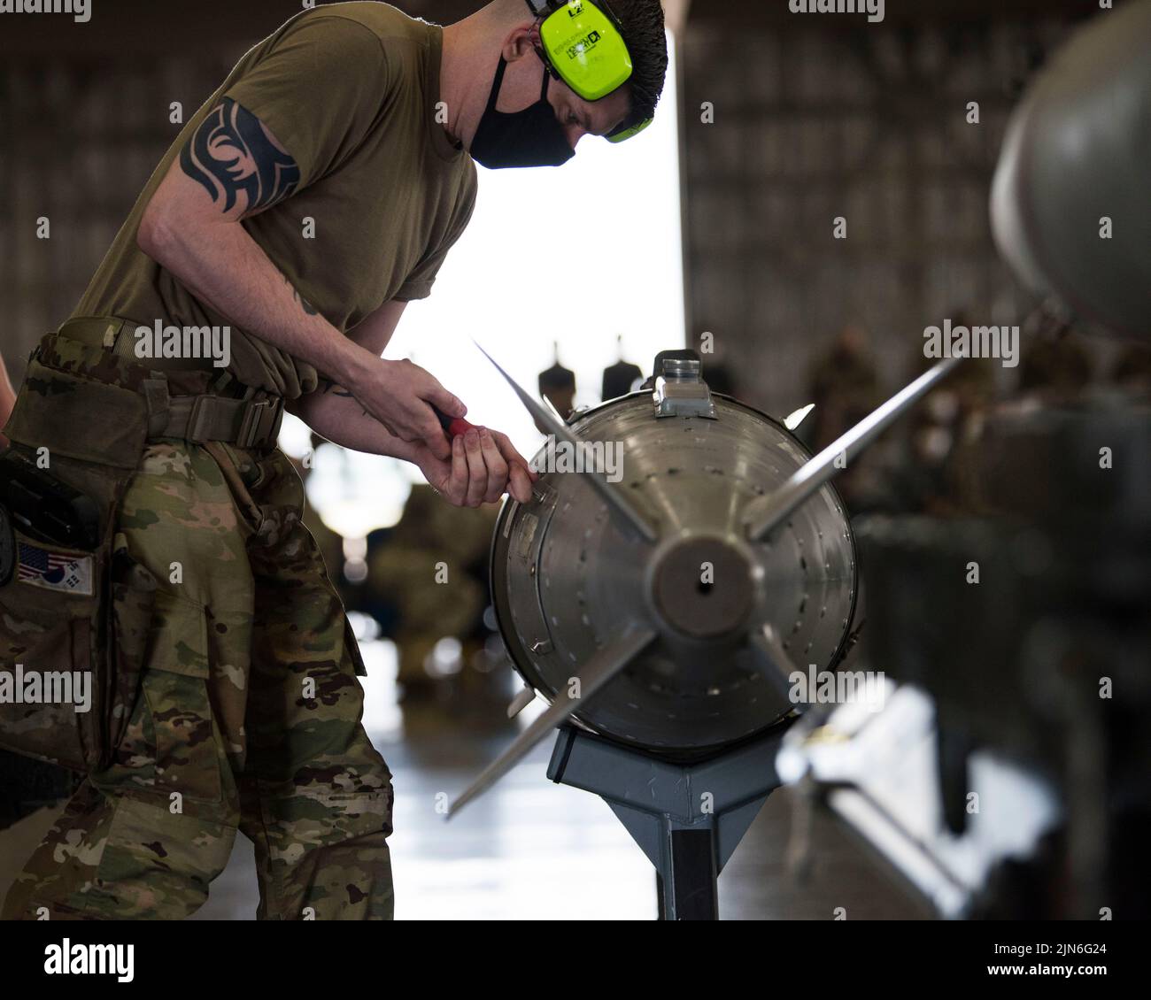 U.S. Air Force Staff Sgt. Kevin Myers, 14th Aircraft Maintenance Unit weapons load team chief, tightens screws on a training GBU-31 guided bomb during the second quarter load competition at Misawa Air Base, Japan, July 16, 2021. This event aids in enhancing both teams readiness, performance and technical abilities. (U.S. Air Force photo by Airman 1st Class Leon Redfern) Stock Photo