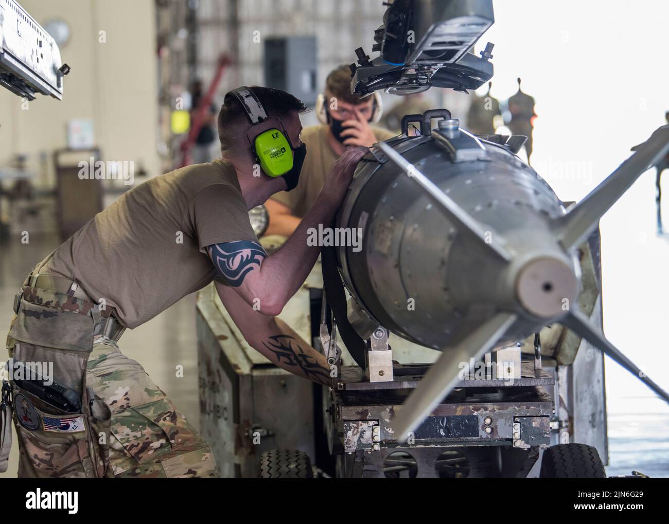 U.S. Air Force Staff Sgt. Kevin Myers, 14th Aircraft Maintenance Unit (AMU) weapons load team chief, secures a training GBU-31, a guided bomb, to the weapons sub-assembly on an F-16 Fighting Falcon during the second quarter load competition at Misawa Air Base, Japan, July 16, 2021. Load crews from the 13th and 14th AMU take part in this competition, ensuring readiness and proper munitions handling in a timely manner. (U.S. Air Force photo by Airman 1st Class Leon Redfern) Stock Photo