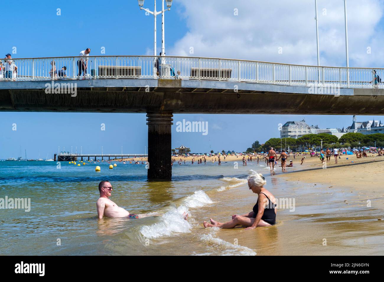 Two people, a man and a woman sitting in the water on the beach of Arcachon. Arcachon beach, the Belisaire pier, the embarkations, the lovers, the bathers, a day at the beach. August 04, 2022. Photo by Patricia Huchot-Boissier/ABACAPRESS.COM Stock Photo