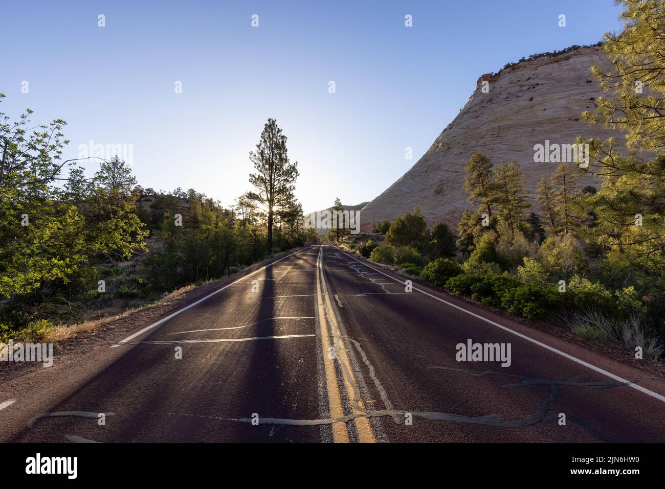 Scenic Road in American Mountain Landscape. Sunny Morning Sunrise Sky Stock Photo