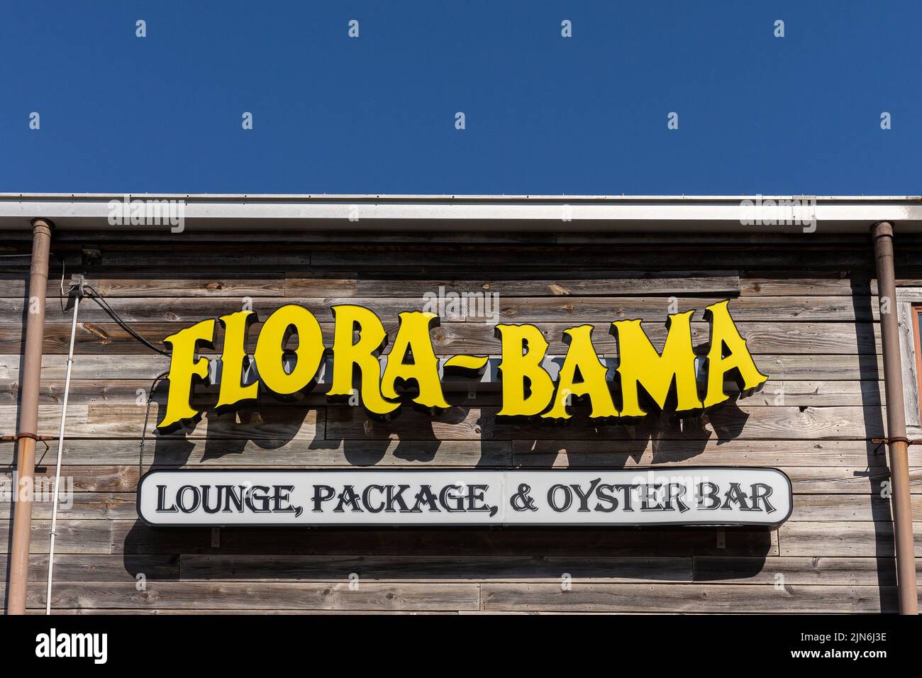 Perdido Key, FL - March 27, 2022: Sign outside the famous Flora-Bama beach and oyster bar.  The Flora-Bama is a well-known landmark, straddling the st Stock Photo
