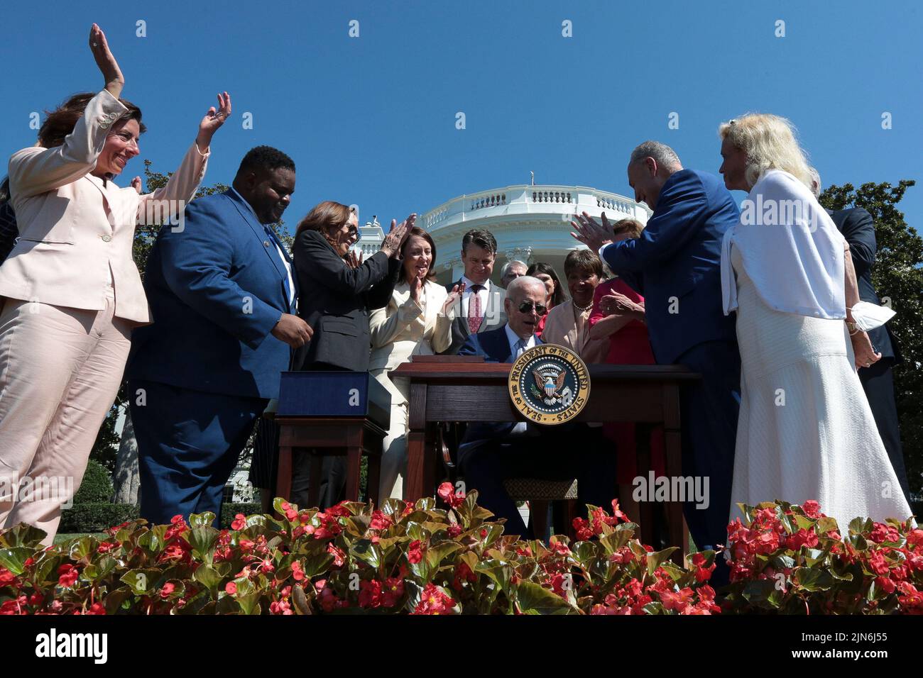 President Joe Biden, center, signs into law H.R. 4346, the CHIPS and