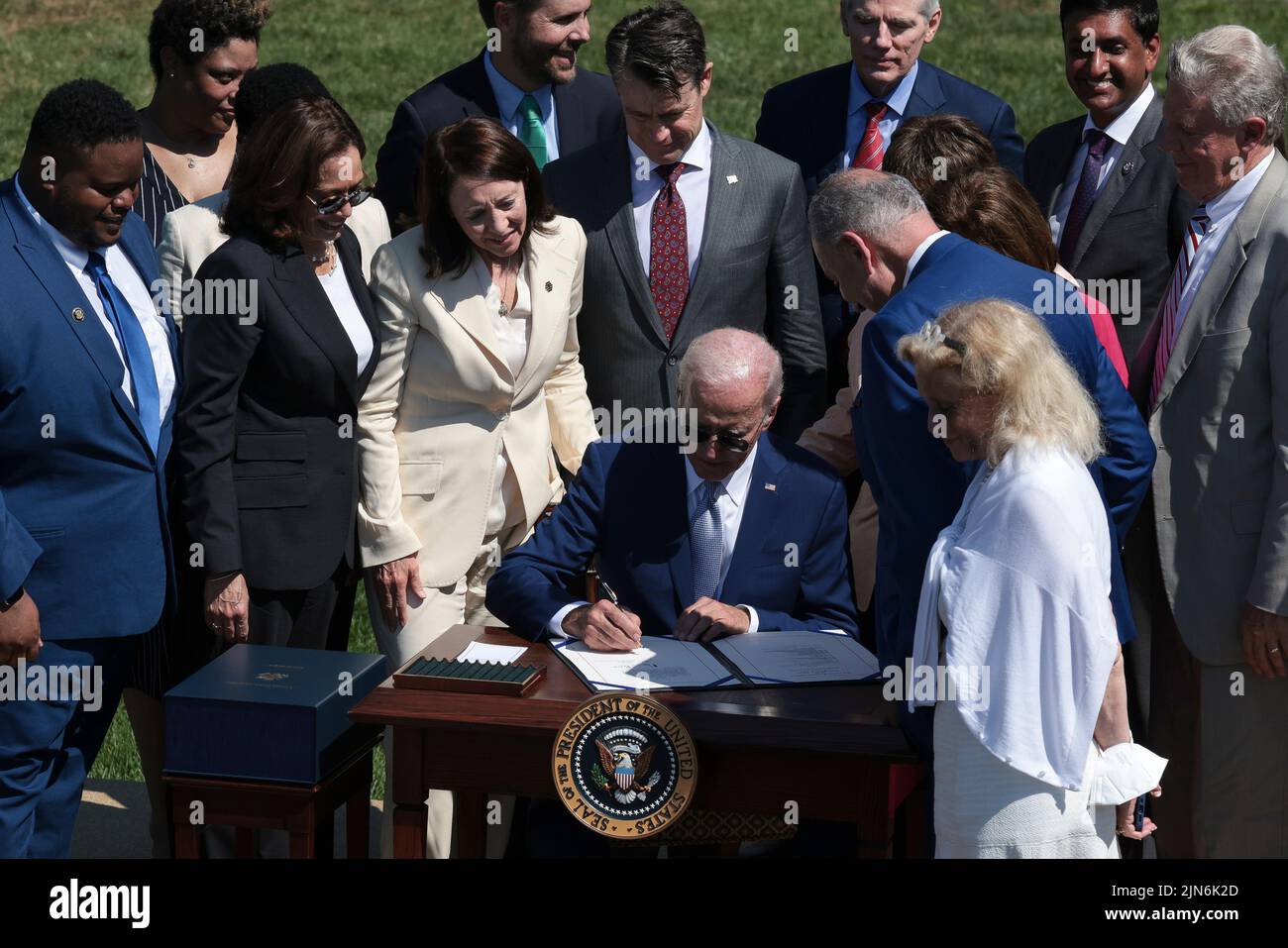 President Joe Biden, center, signs into law H.R. 4346, the CHIPS and