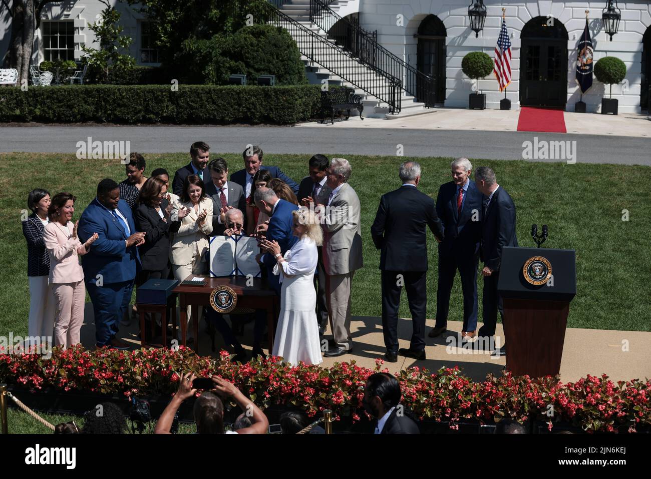 President Joe Biden, center, signs into law H.R. 4346, the CHIPS and