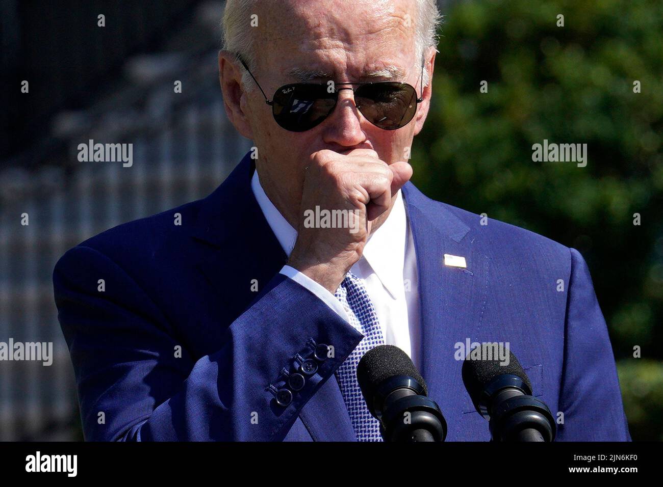 U.S. President Joe Biden coughs as he delivers remarks and sign into law the CHIPS and Science Act during a ceremony on the South Lawn of the White House in Washington on August 9, 2022. Photo by Yuri Gripas/ABACAPRESS.COM Stock Photo