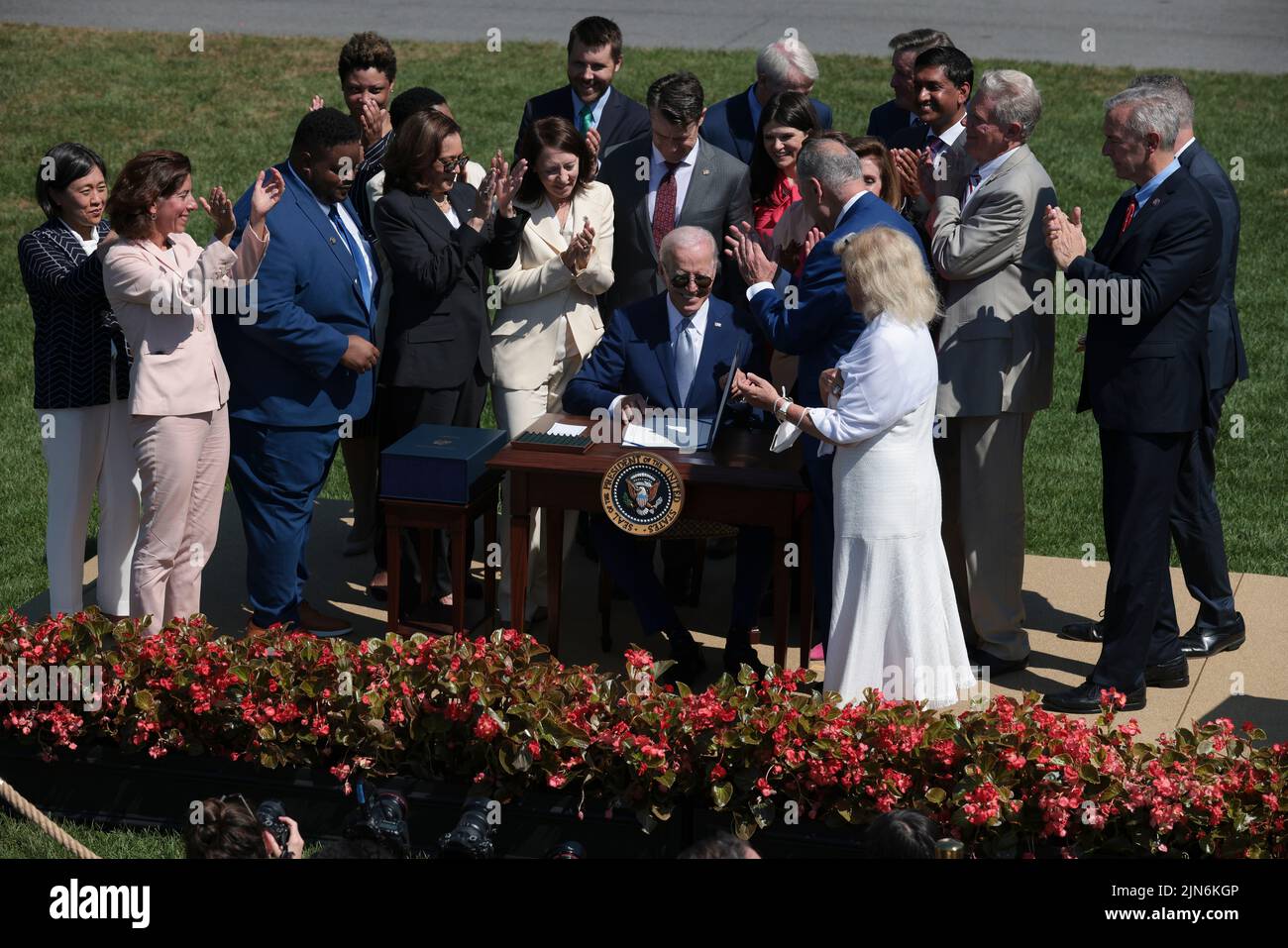 President Joe Biden, center, signs into law H.R. 4346, the CHIPS and