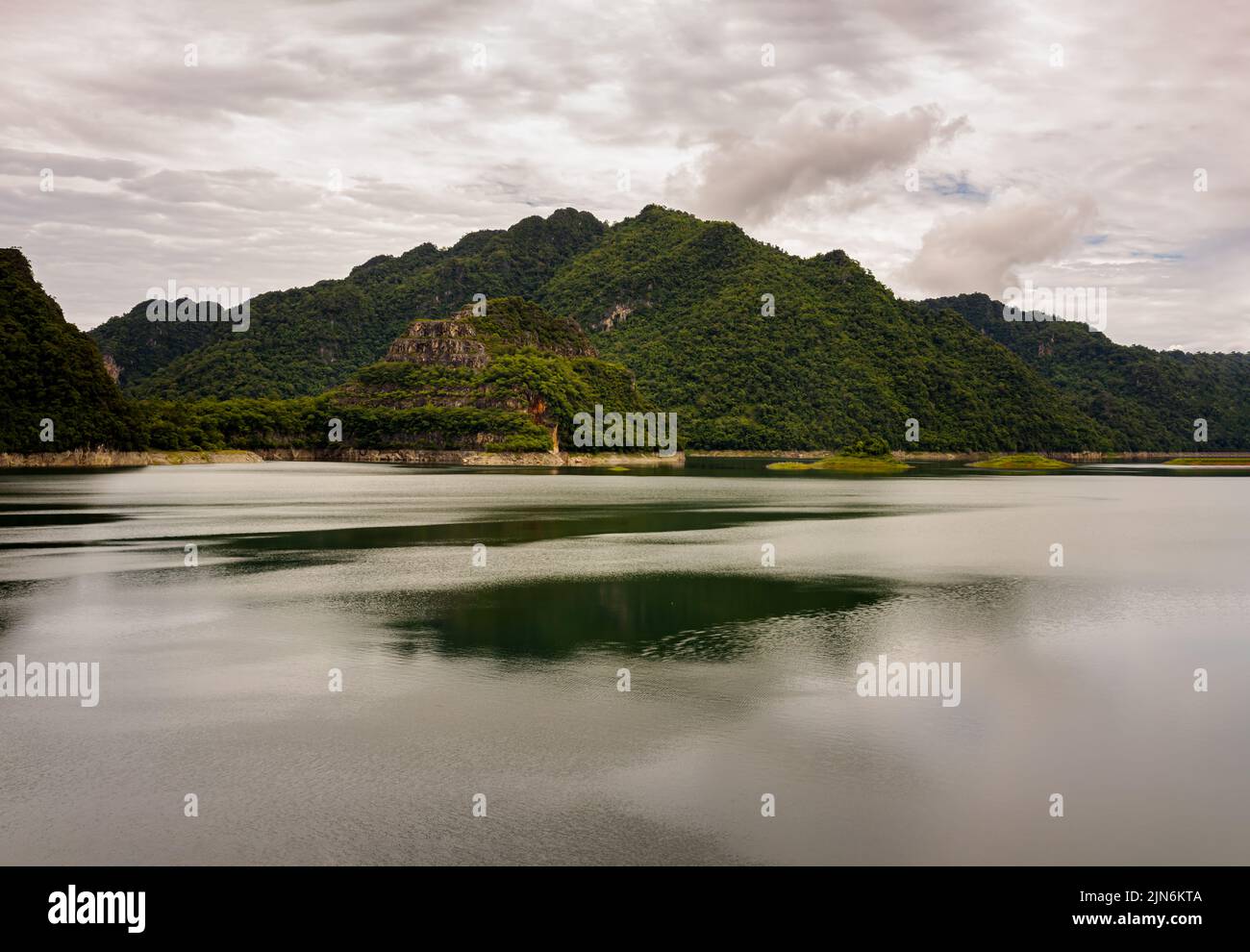 Natural scenery of water in reservoirs and dam with sky and mountains range in background. Copy space, Selective focus. Stock Photo