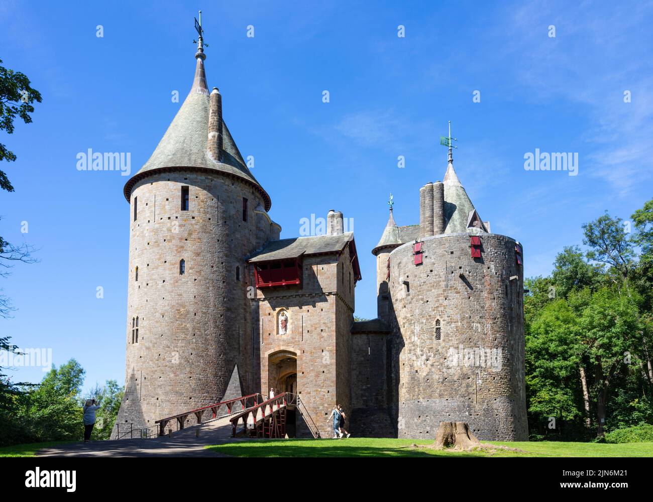 Two people walking towards Castell Coch Castle Coch or Red Castle Tongwynlais Cardiff South Wales UK GB Europe Stock Photo