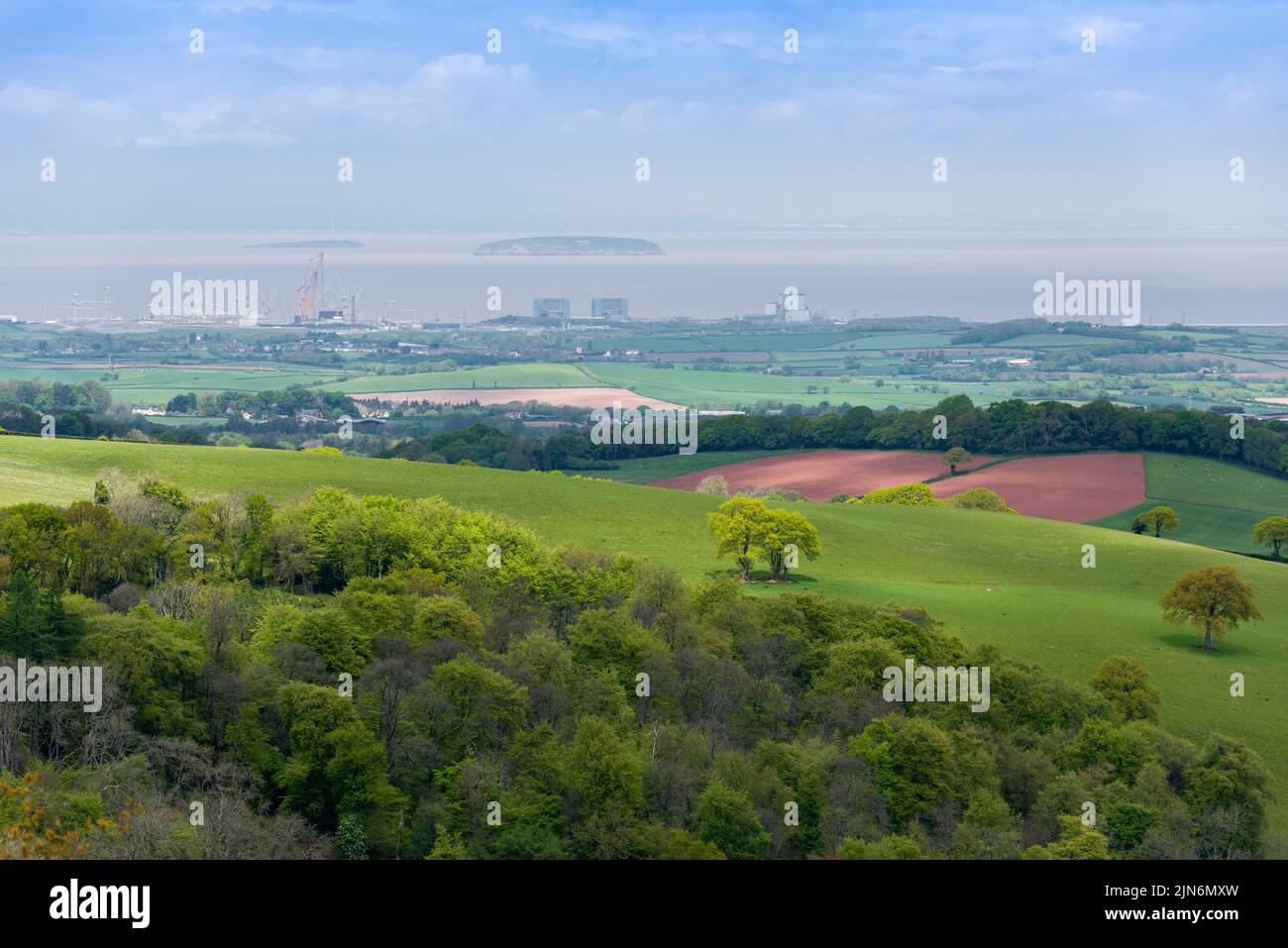 The Hinckley Point power stations, including the construction site for Hinkley C, from Cothelstone Hill in the Quantock Hills with the islands of Flat Holm and Steep Holm in the Bristol Channel beyond, Somerset, England. Stock Photo