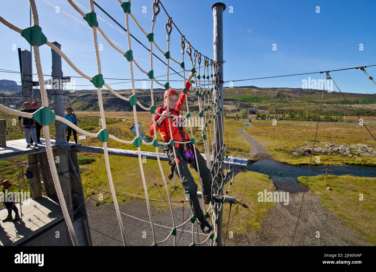 boy playing at high rope access course in Iceland Stock Photo