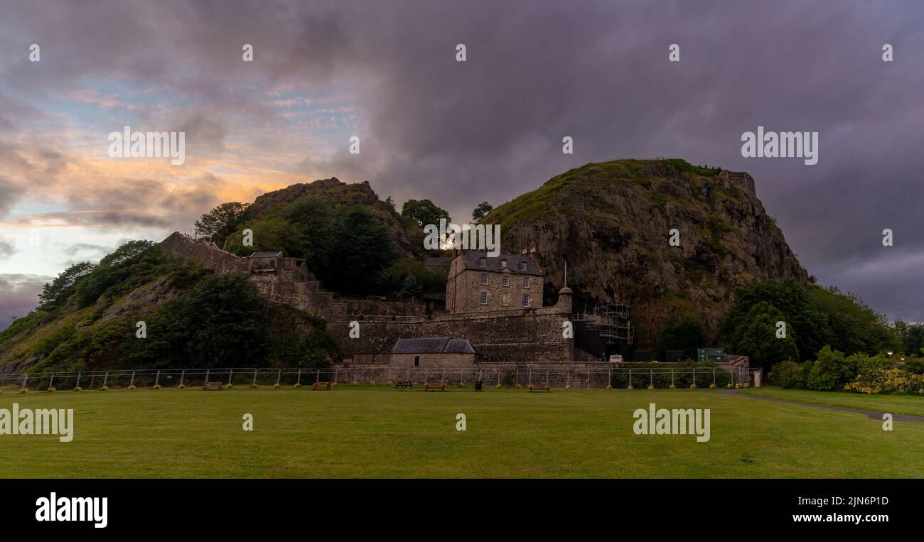 Dumbarton, United Kingdom - 4 July, 2022: panorama view of Dumbarton Castle and Dumbarton Rock on the Clyde River at sunset Stock Photo