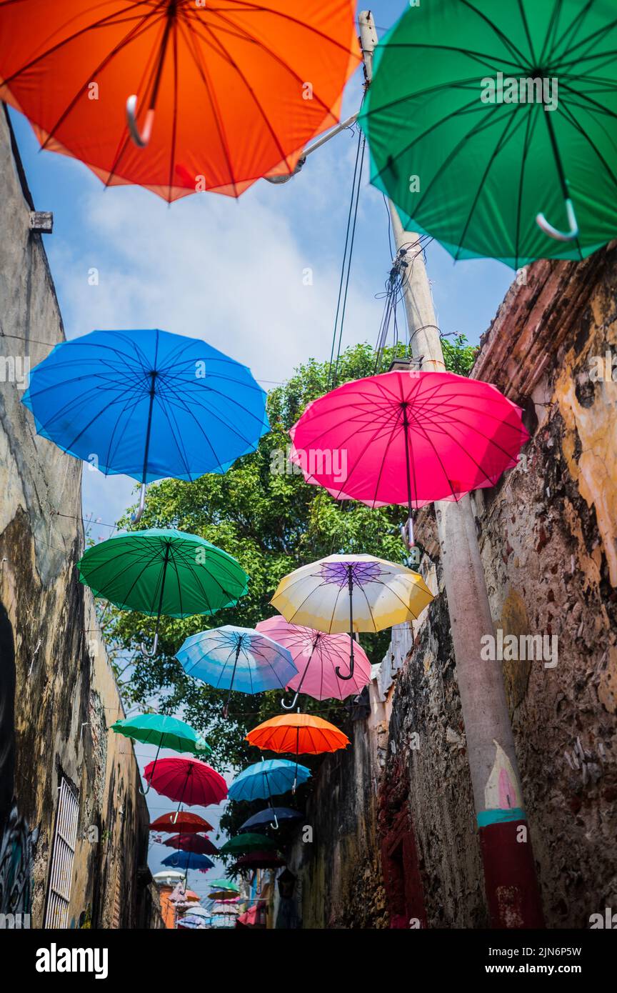 Popular Umbrella-covered street in the cool neighbourhood of Getsemani, Cartagena de Indias, Colombia Stock Photo