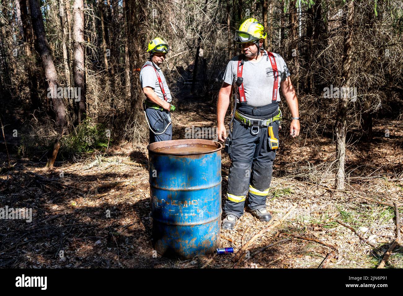 Hrensko, Czech Republic. 09th Aug, 2022. The burnt forests in the Ceske Svycarsko (Czech Switzerland) National Park, Czech Republic, August 9, 2022. Volunteer firefighters from Kresice in the Decin region walks by water barrel in the Sandy Ravine above the Edmund (Silent) Gorge, where he is guarding part of the first area handed over by the firefighters to the park administration after the firefighting is finished. Credit: Ondrej Hajek/CTK Photo/Alamy Live News Stock Photo
