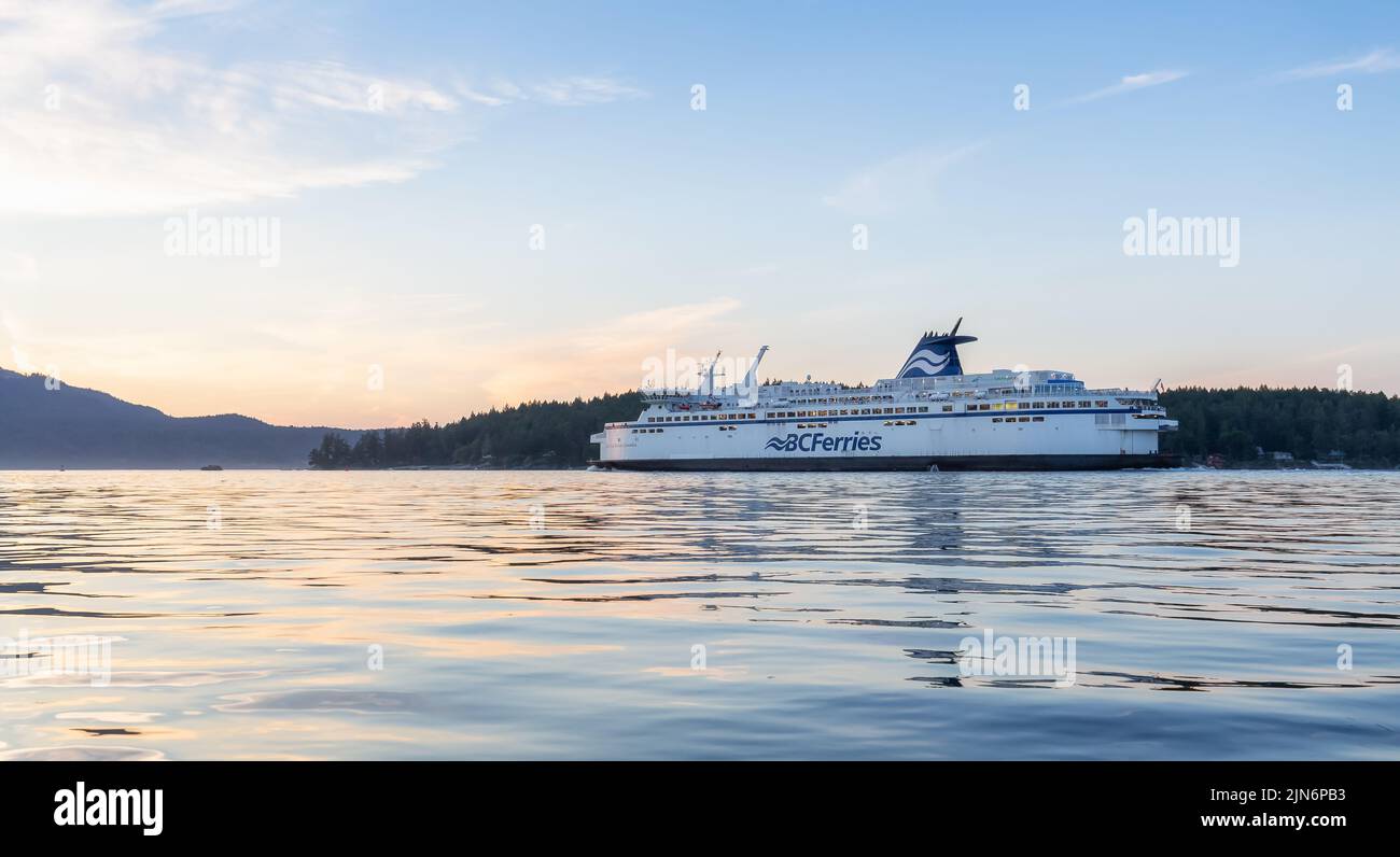 BC Ferries Boat leaving the Terminal in Swartz Bay during colorful summer sunset. Stock Photo