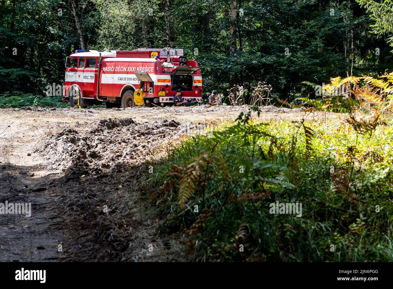 Hrensko, Czech Republic. 09th Aug, 2022. The burnt forests in the Ceske Svycarsko (Czech Switzerland) National Park, Czech Republic, August 9, 2022. Volunteer firefighters from Kresice in the Decin region patrol near their vehicle in the Sandy Ravine above the Edmund (Silent) Gorge, where he is guarding part of the first area handed over by the firefighters to the park administration after the firefighting is finished. Credit: Ondrej Hajek/CTK Photo/Alamy Live News Stock Photo