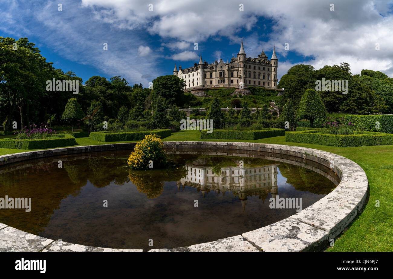 Golspie, United Kingdom - 25 June, 2022: view of Dunrobin Castle and Gardens in the Scottish Highlands and castle reflection in the fountain Stock Photo