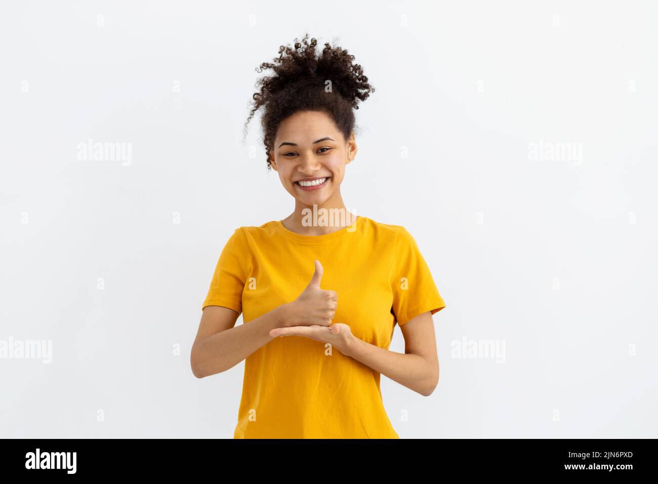 Deaf mute young African American woman white background Stock Photo