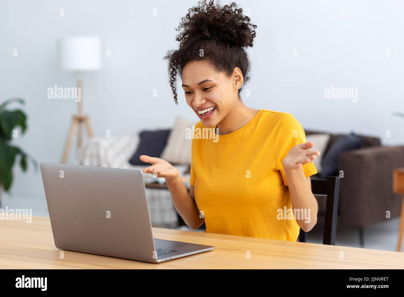 happy female student using laptop computer having video call sitting learning language Stock Photo