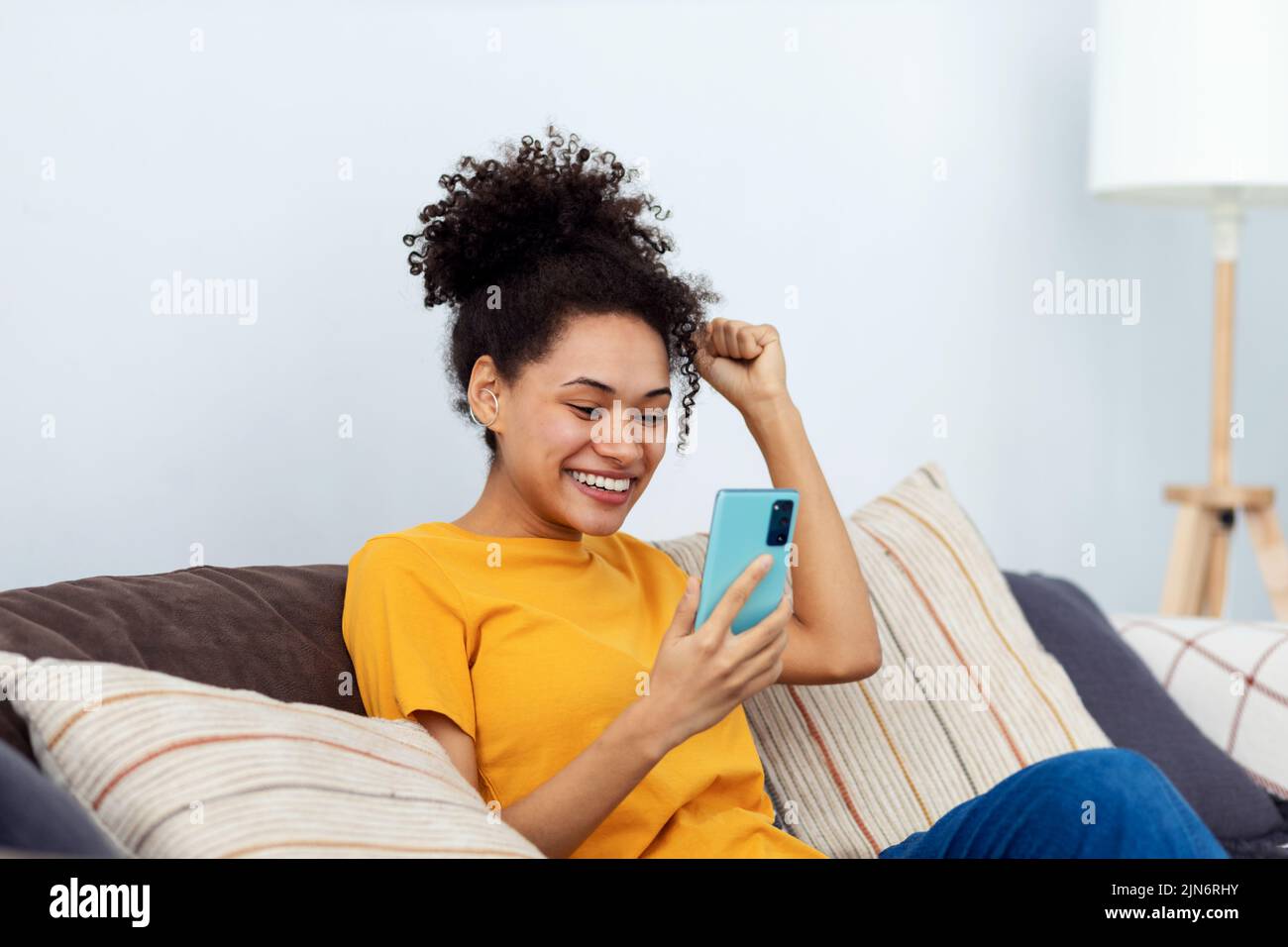 Excited woman received a good message on the mobile phone happy with great news Stock Photo