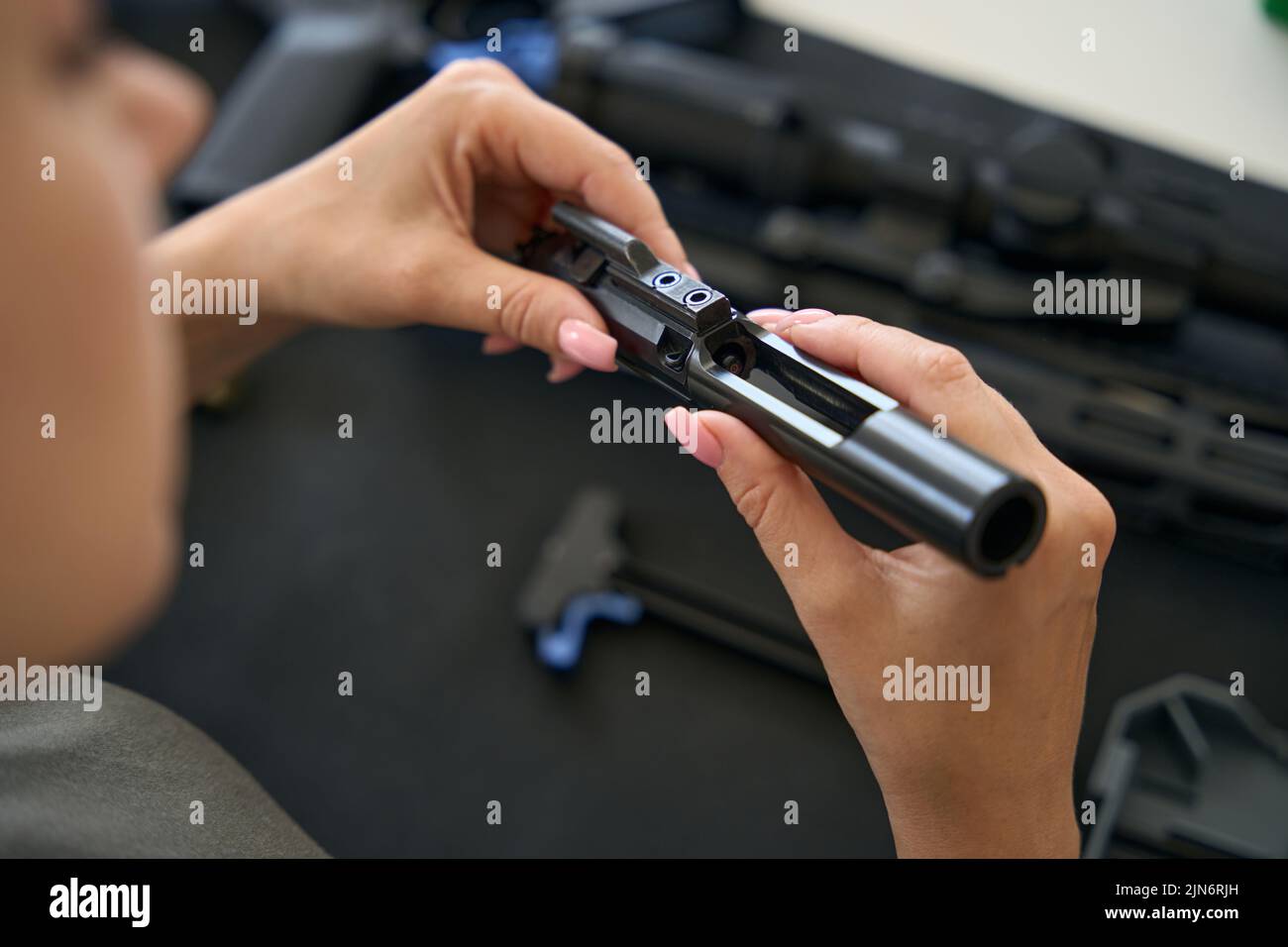 Detail of a modern weapon in the hands of woman Stock Photo - Alamy
