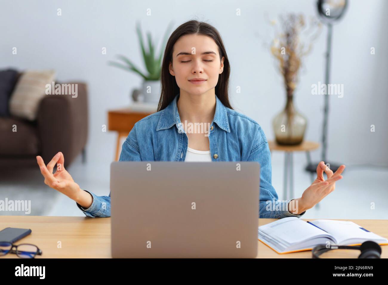 Young woman meditating eyes closed thinking of good things and focusing on positive feelings and emotions Stock Photo