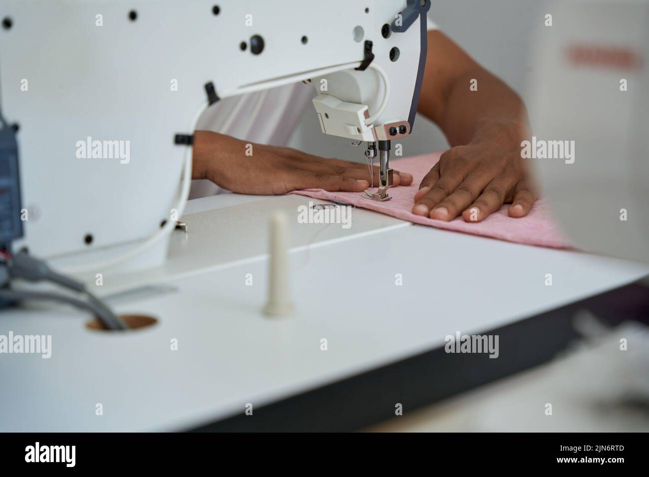 African American male dressmaker working in atelier Stock Photo