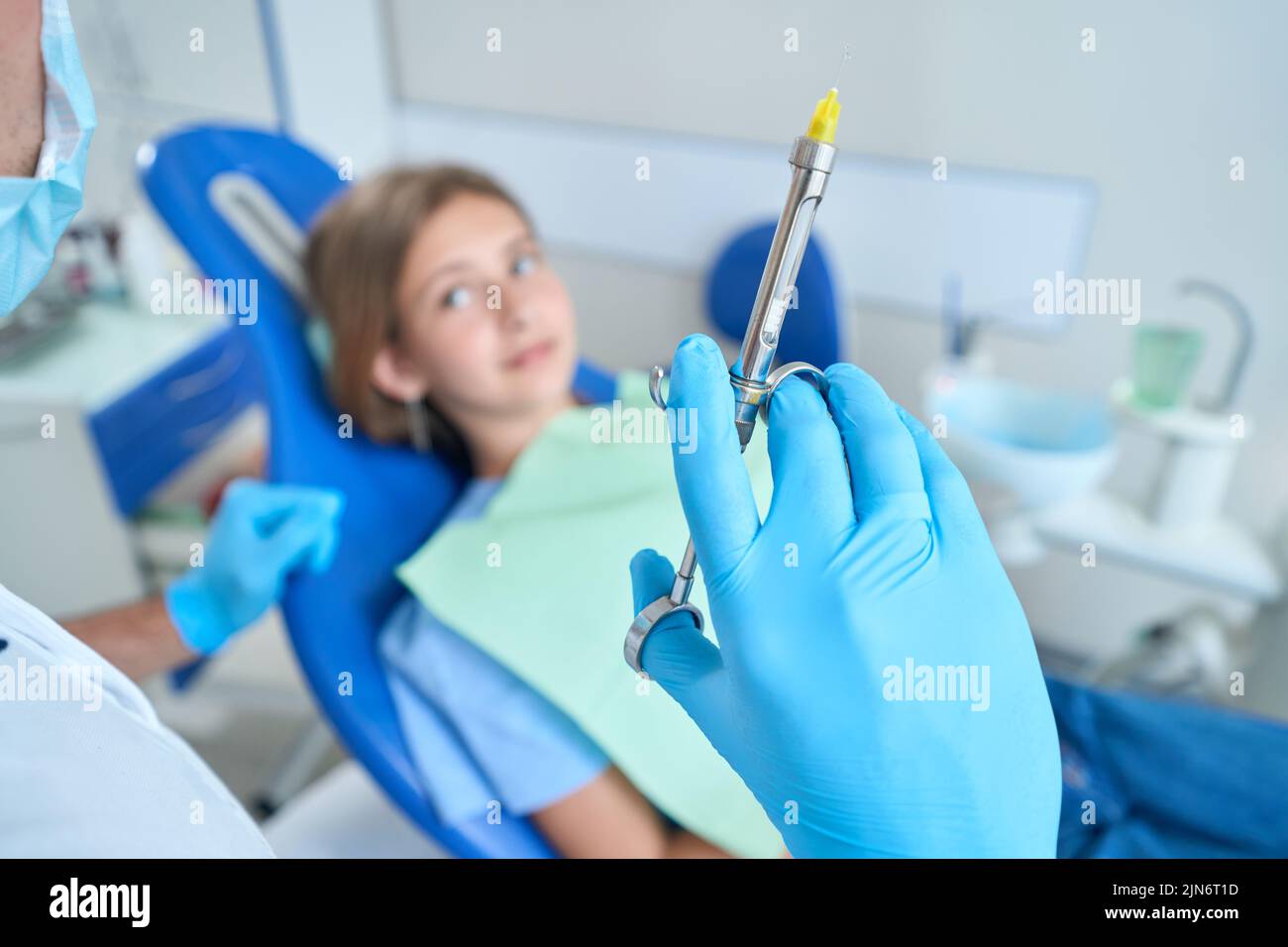 Pediatric dentist preparing to give local anesthetic to teenage patient Stock Photo Alamy