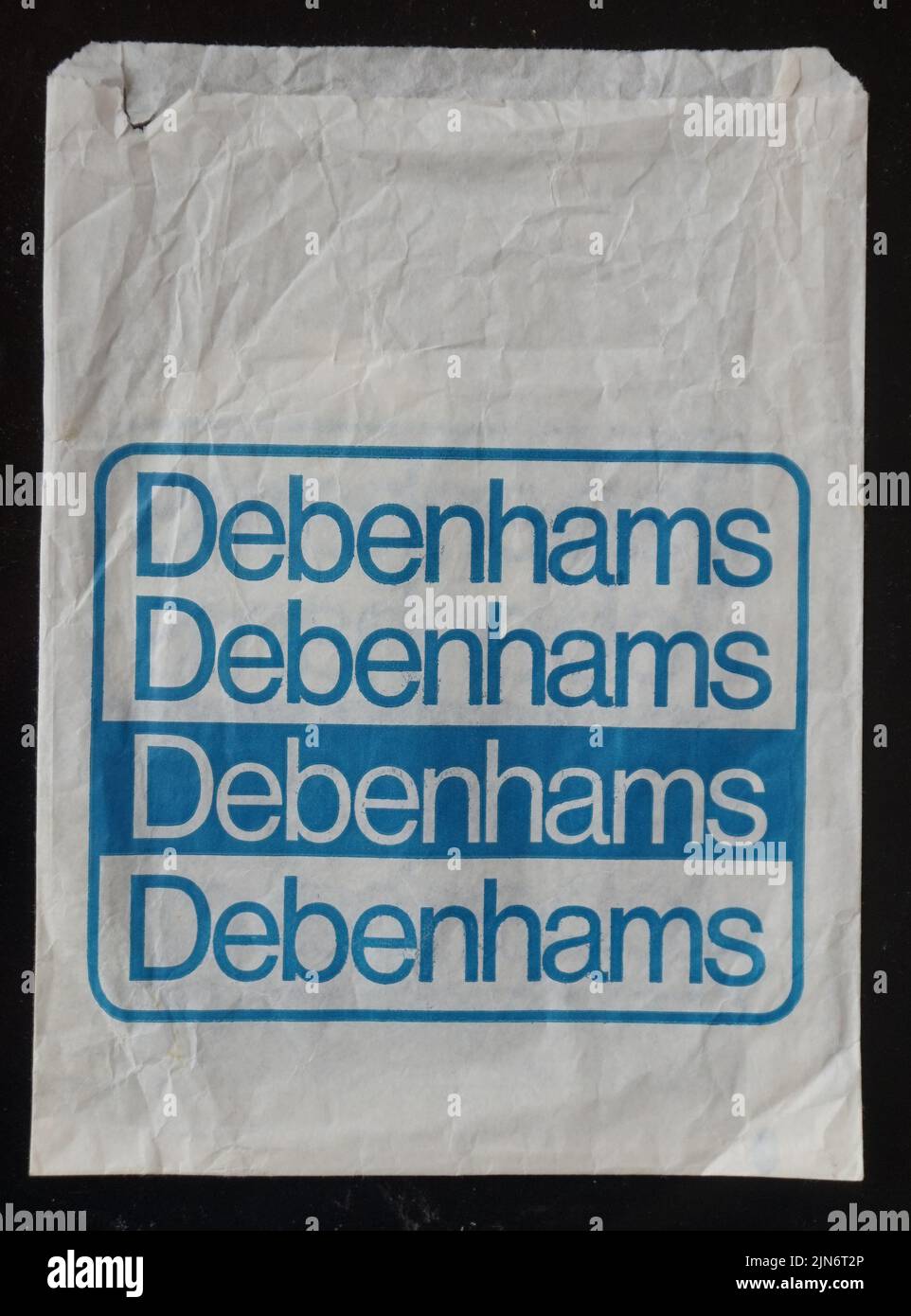 Debenhams paper in store bag, functional piece of graphic packaging design. This famous British chain of department stores has closed in recent years (2021), a victim of private equity asset stripping and high street shopping changes. Paper ephemera. Stock Photo