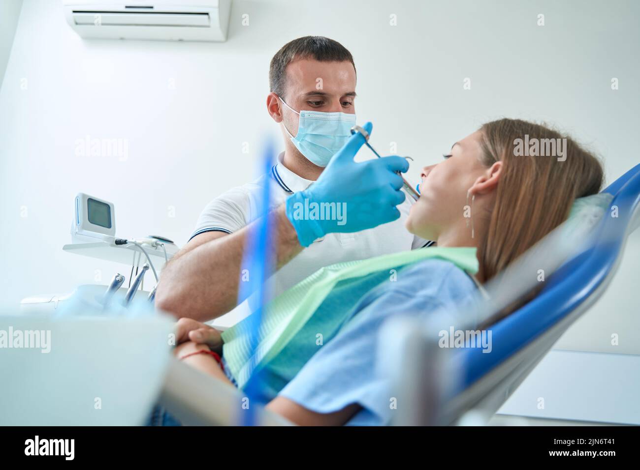 Pediatric dentist using local anesthesia before dental procedure Stock
