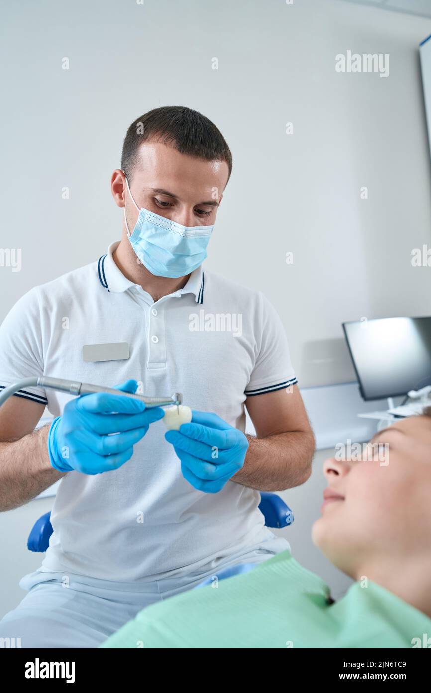 Professional pediatric dentist conducting restorative dentistry procedure Stock Photo Alamy