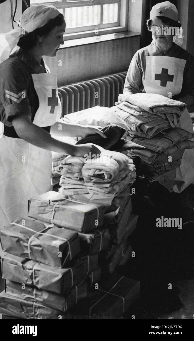 Gifts From America -- Some of the gifts from America being sorted by British Red Cross nurses for distribution.British Red Cross nurses are distributing gifts from America and elsewhere to various hospitals in the country. March 07, 1941. (Photo by Fox Photos). Stock Photo