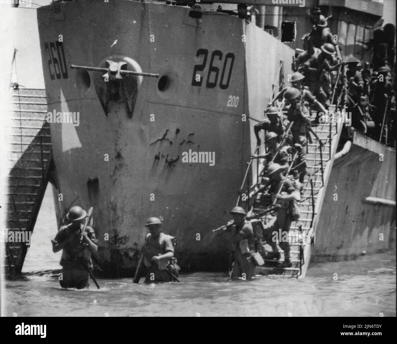 Invasion of Sicily Early Stages of the Landing -- Infantry coming down the steps from landing craft.Thousands of craft of all types were used in the invasion of Sicily, including entirely new types. Here are some of the early scene during and after the landing which began on July 10. July 17, 1943. (Photo by British Official Photo). Stock Photo