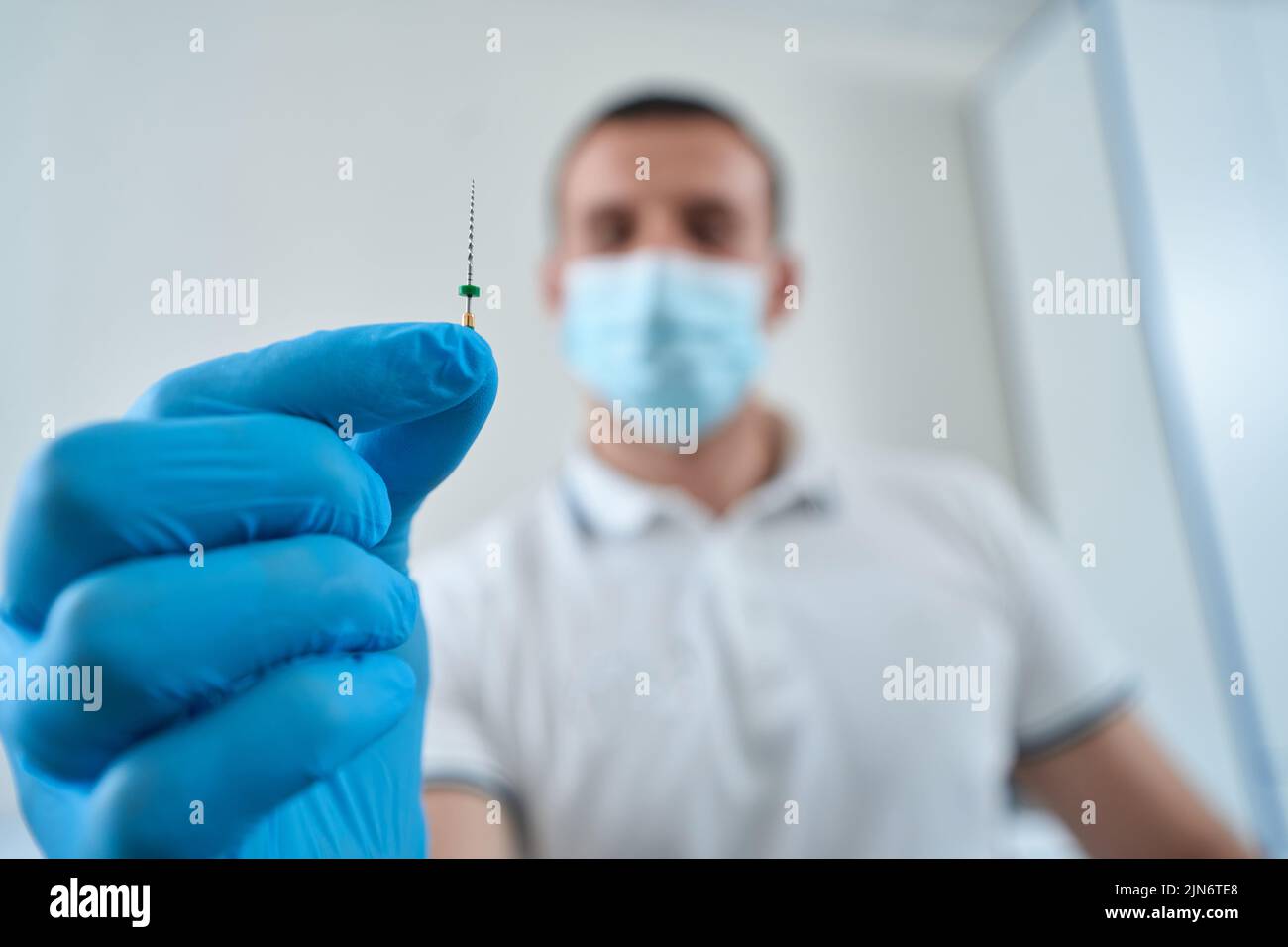Dental professional showing medical tool for root canal treatment Stock