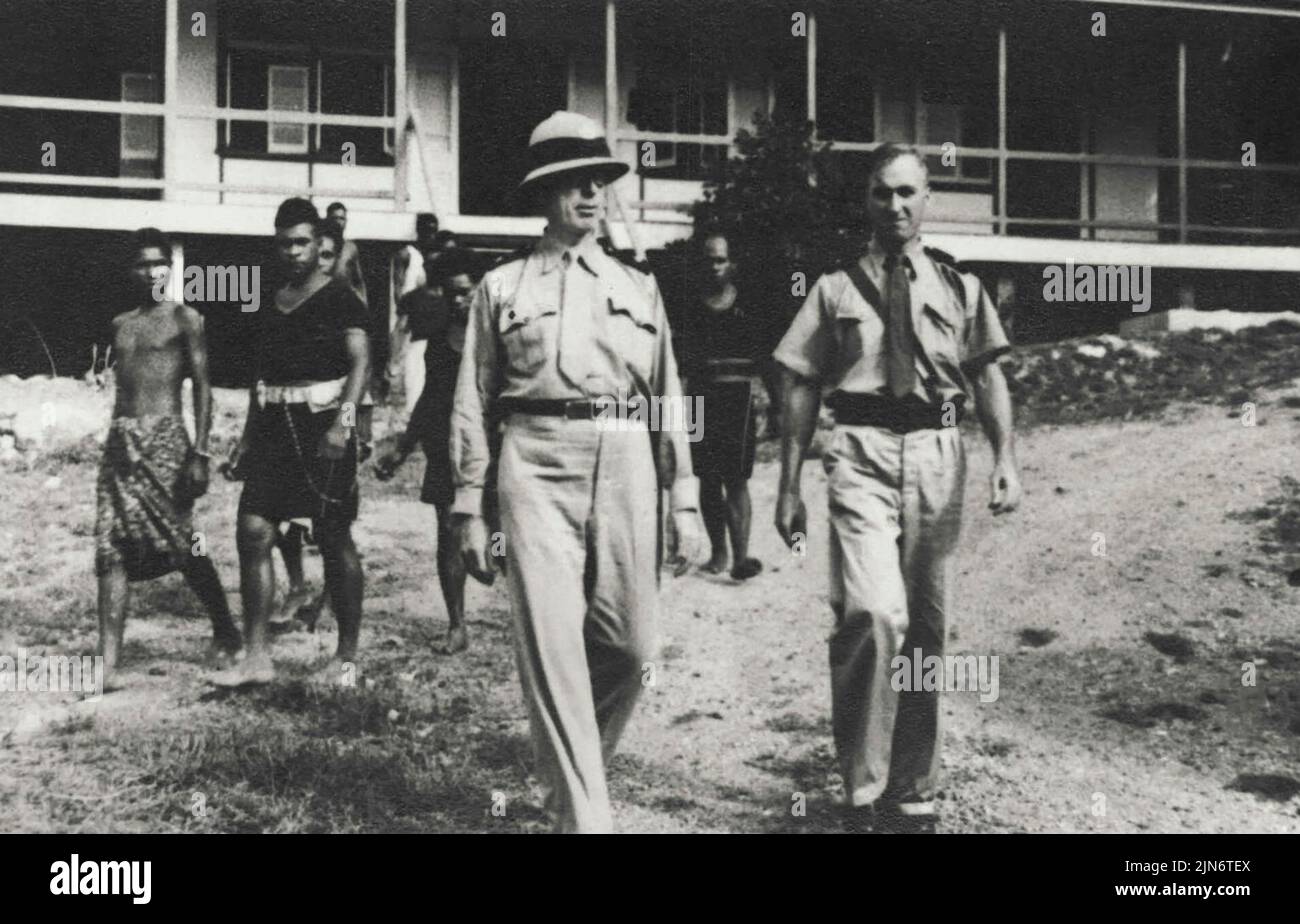 Superintendent Gough (officer on left) leaving Supreme Court, Port Moresby, followed by policemen escorting two native murderers. The murderers bashed 72-year-old Tom Bowes to death with a heavy stick at Moresby last year. They are now serving Life sentences. November 06, 1950. (Photo by Papuan Prints). Stock Photo