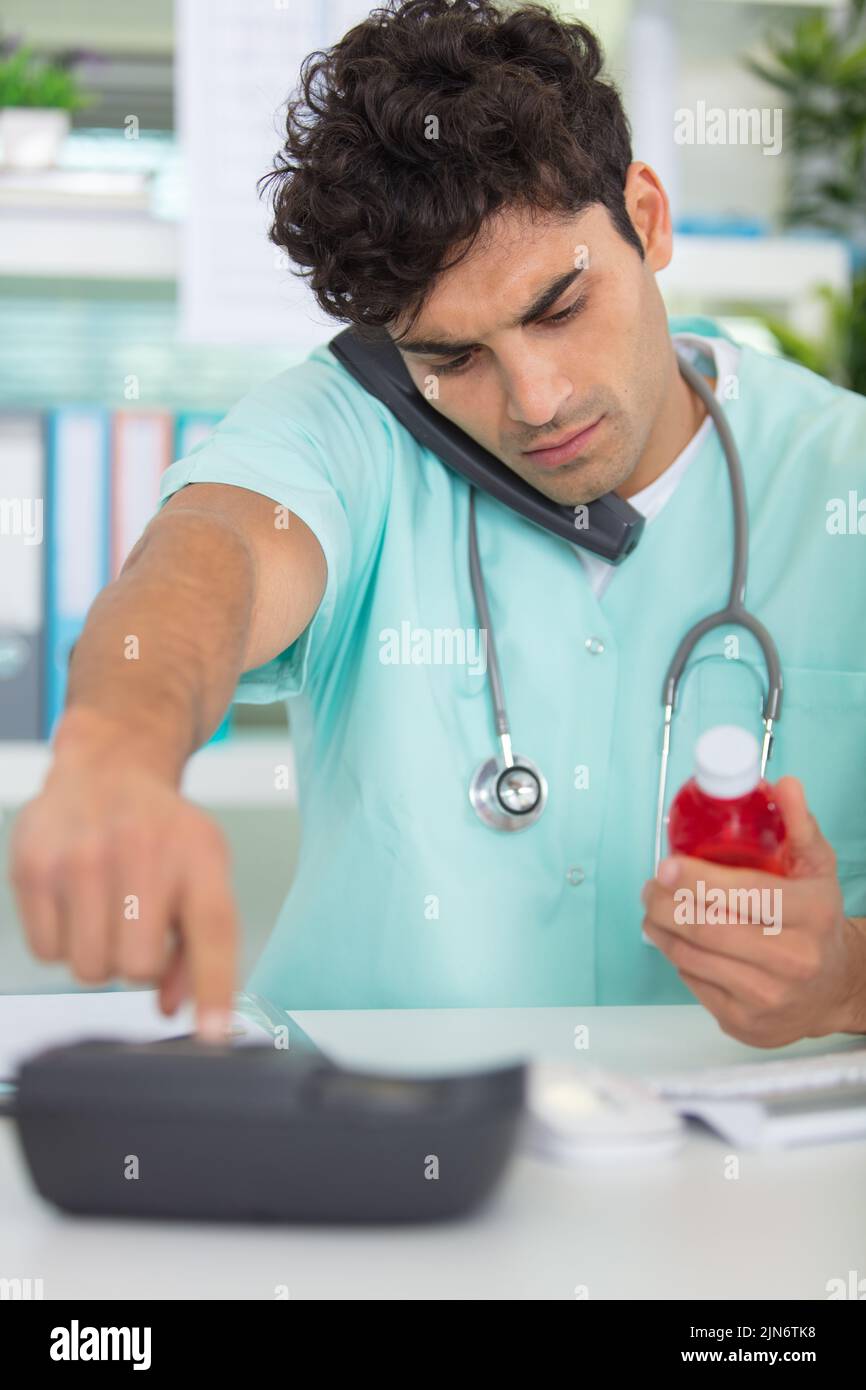 young doctor on phone at his office Stock Photo