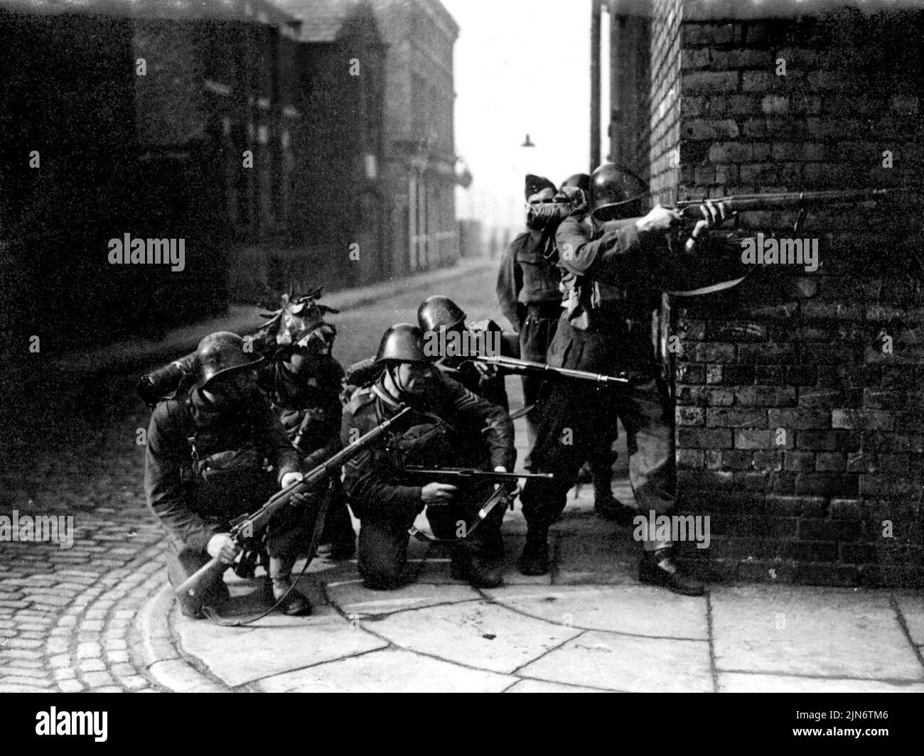 Dutch 'Invade' Birkenhead -- A party of Dutch soldiers, part of the army that 'invaded' Birkenheas, yesterday, pictures snipping from a street corner. Though 50% of them were 'wopes out' by home guard defenders, the orange-men successfully took the town. August 25, 1941. (Photo by Keystone). Stock Photo