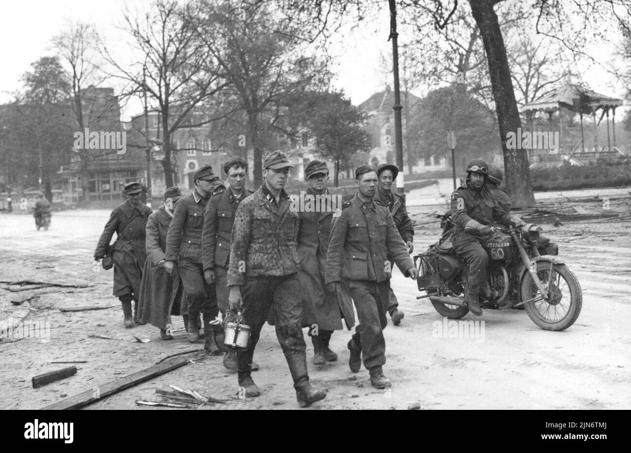 West Ridings Capture Arnhem -- This time it is the Germans who are being marched out of Arnhem - here are the first prisoners captured by the west ridings in the town.The 49th (west riding) division fighting under Canadian command has captured Arnhem and avenged the battering British airborne troops suffered when they attacked the town last September. April 15, 1945. (Photo by Associated Press Photo). Stock Photo