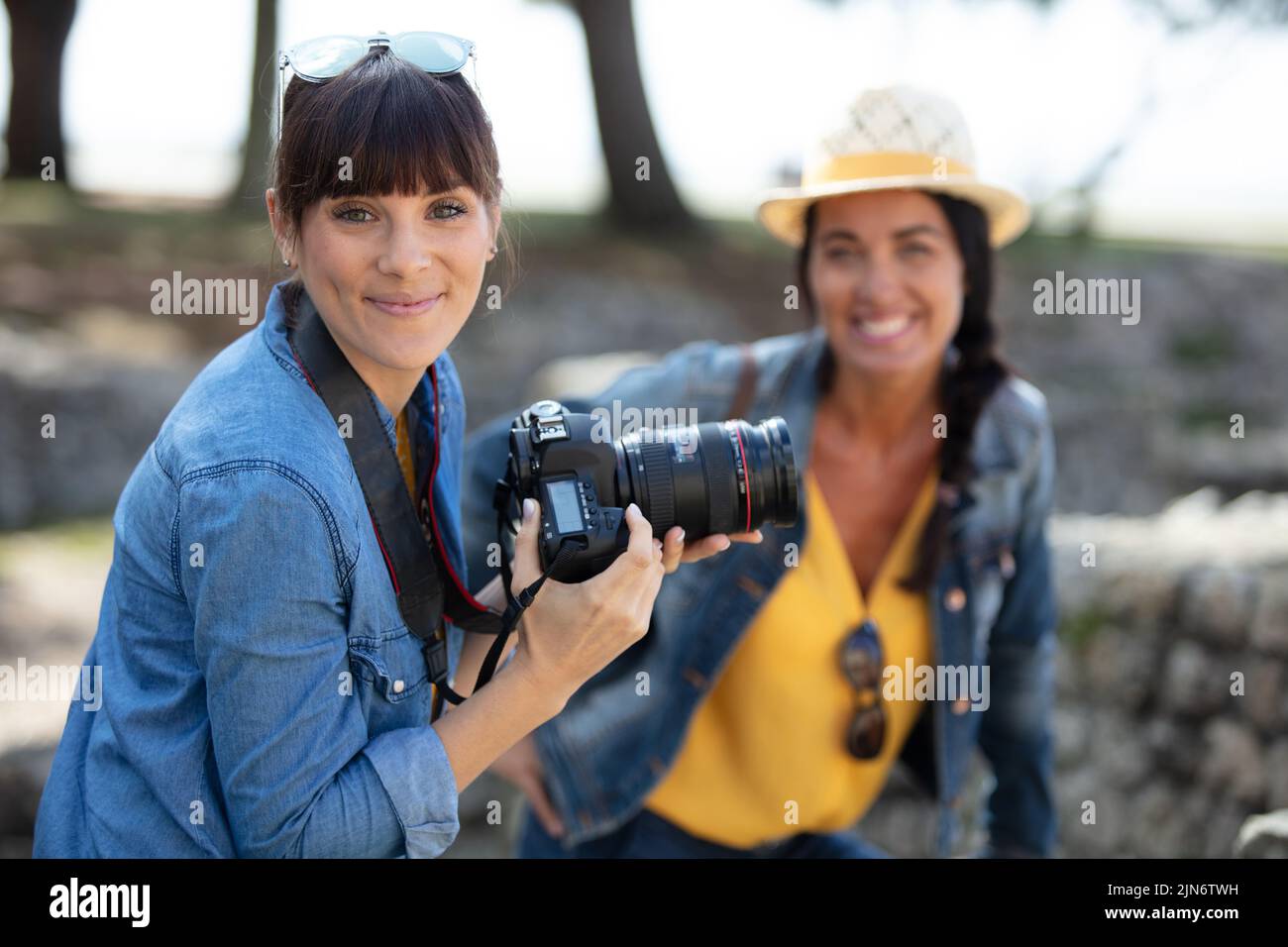 female professional photographer taking womans portrait Stock Photo