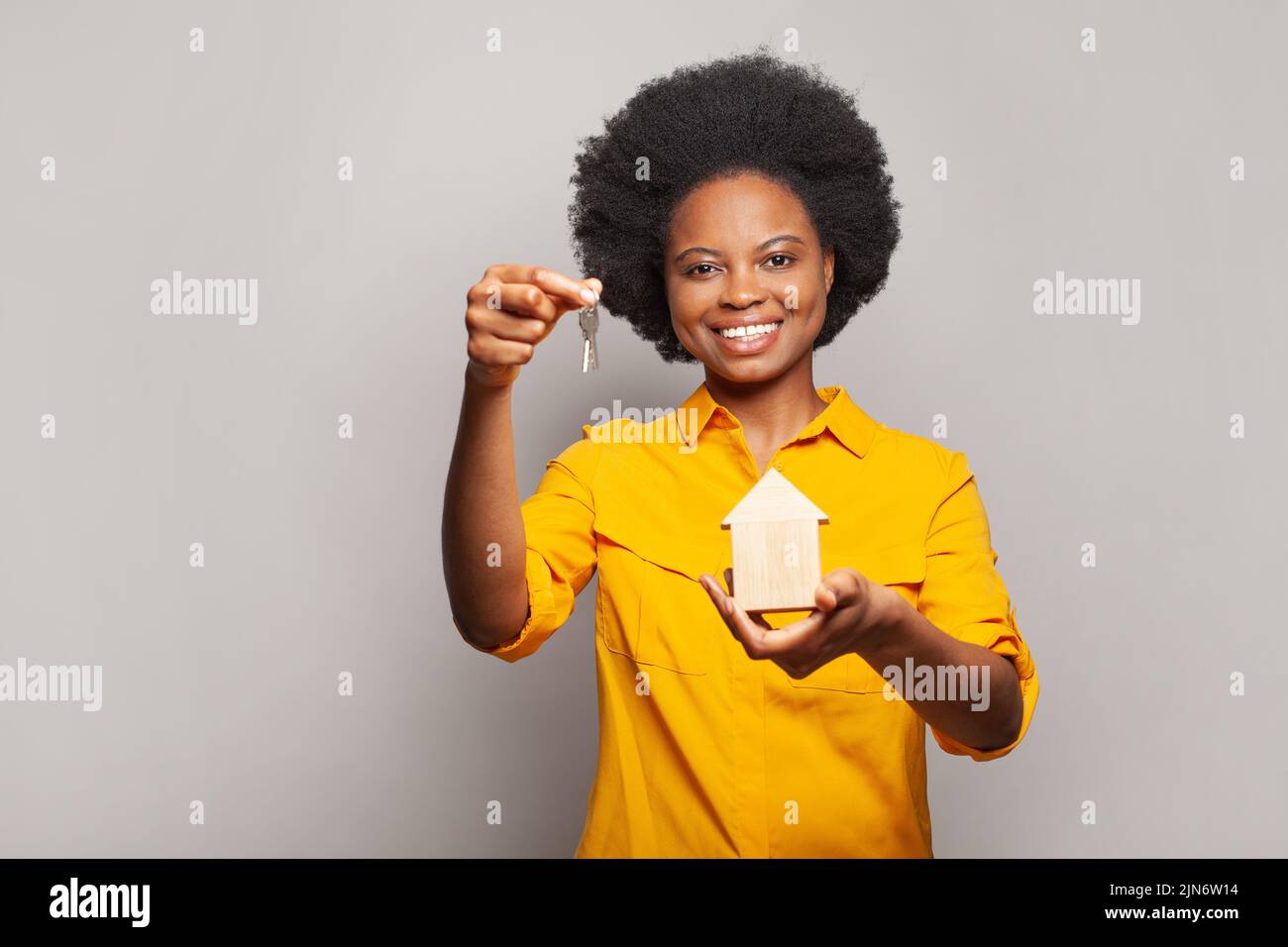Attractive woman holding house keys to new home at camera Stock Photo ...