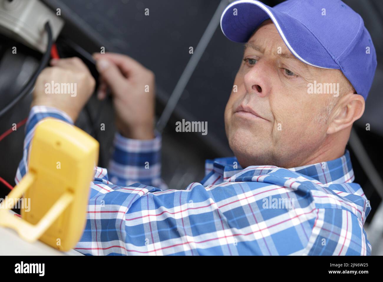technician man hand checking electrical terminal box Stock Photo