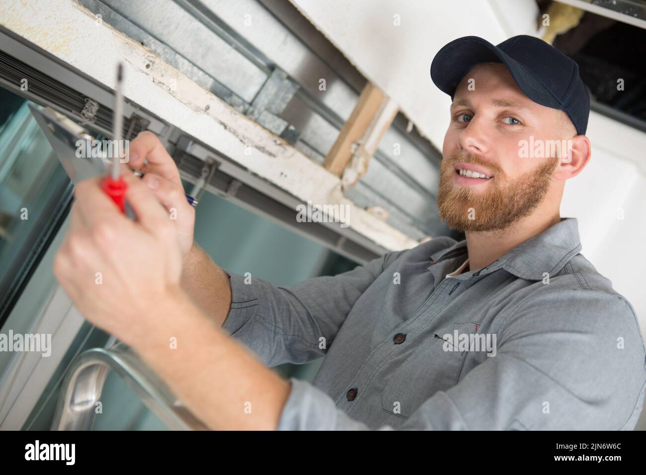 construction worker during replacement window Stock Photo