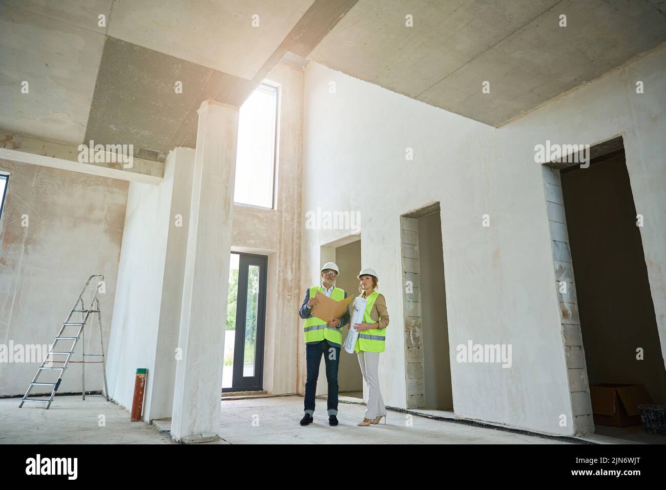 Male foreman with real estate agent discussing a project Stock Photo