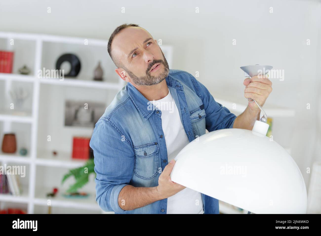 a man is fixing lamps Stock Photo
