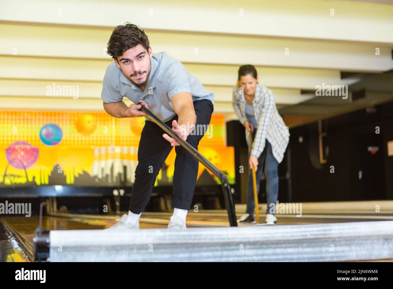 young man cleaning bowling alley Stock Photo
